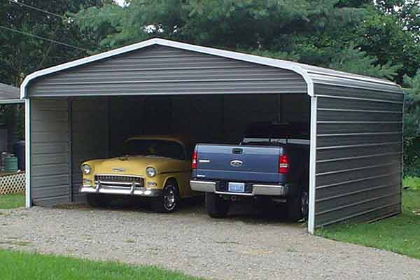 Antique car and a new pickup truck in a standard curved eave carport.