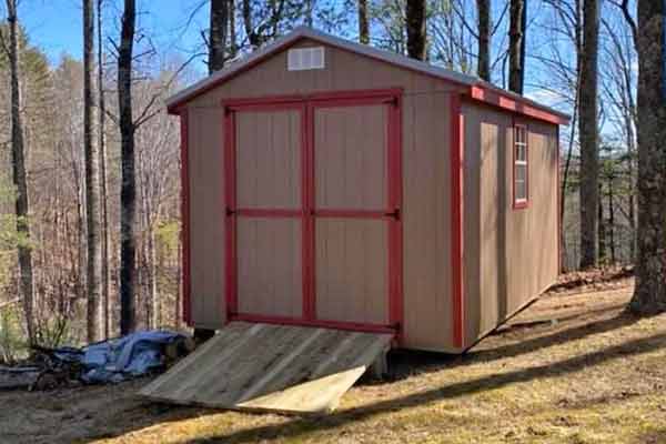 Brown and Red Shed installed on hill.